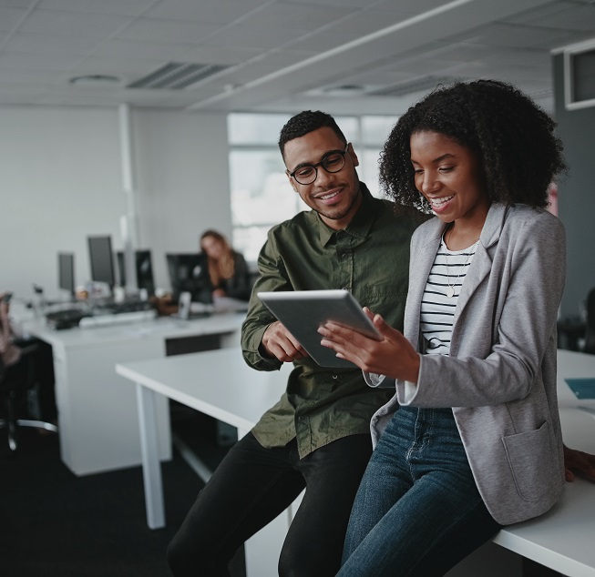 Successful african american business couple talking and using digital tablet