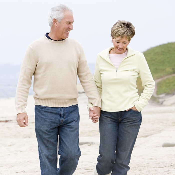 Senior Couple Walking on Beach