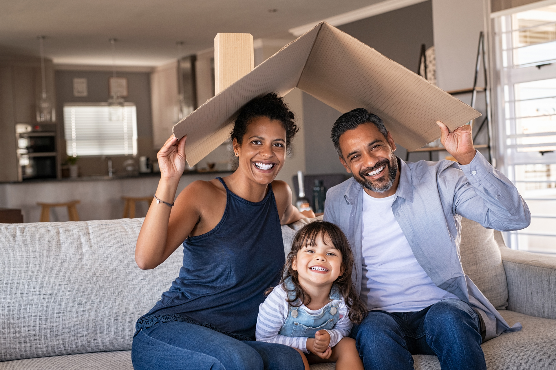 family holding make-shift roof over their heads