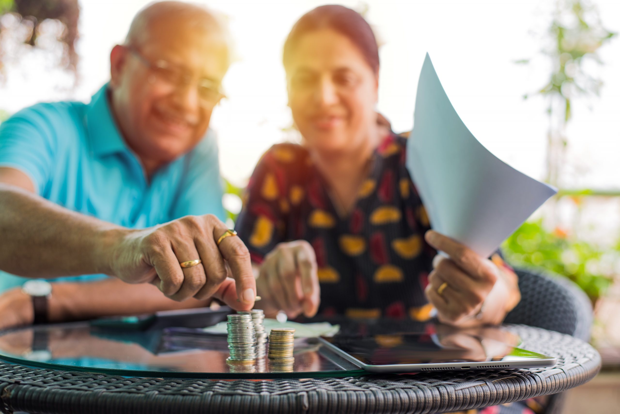 Elderly East Asian couple counting coins