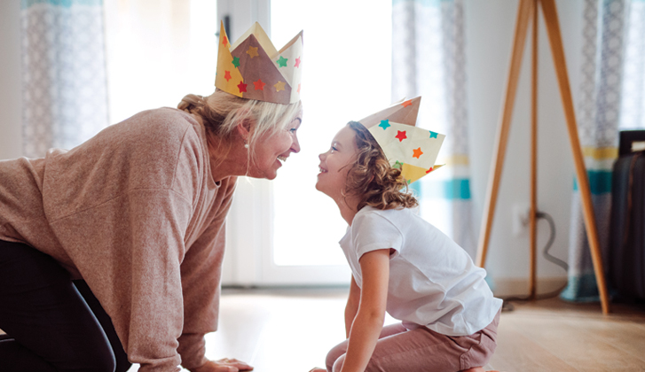 Grandmother with grandchild wearing party hats