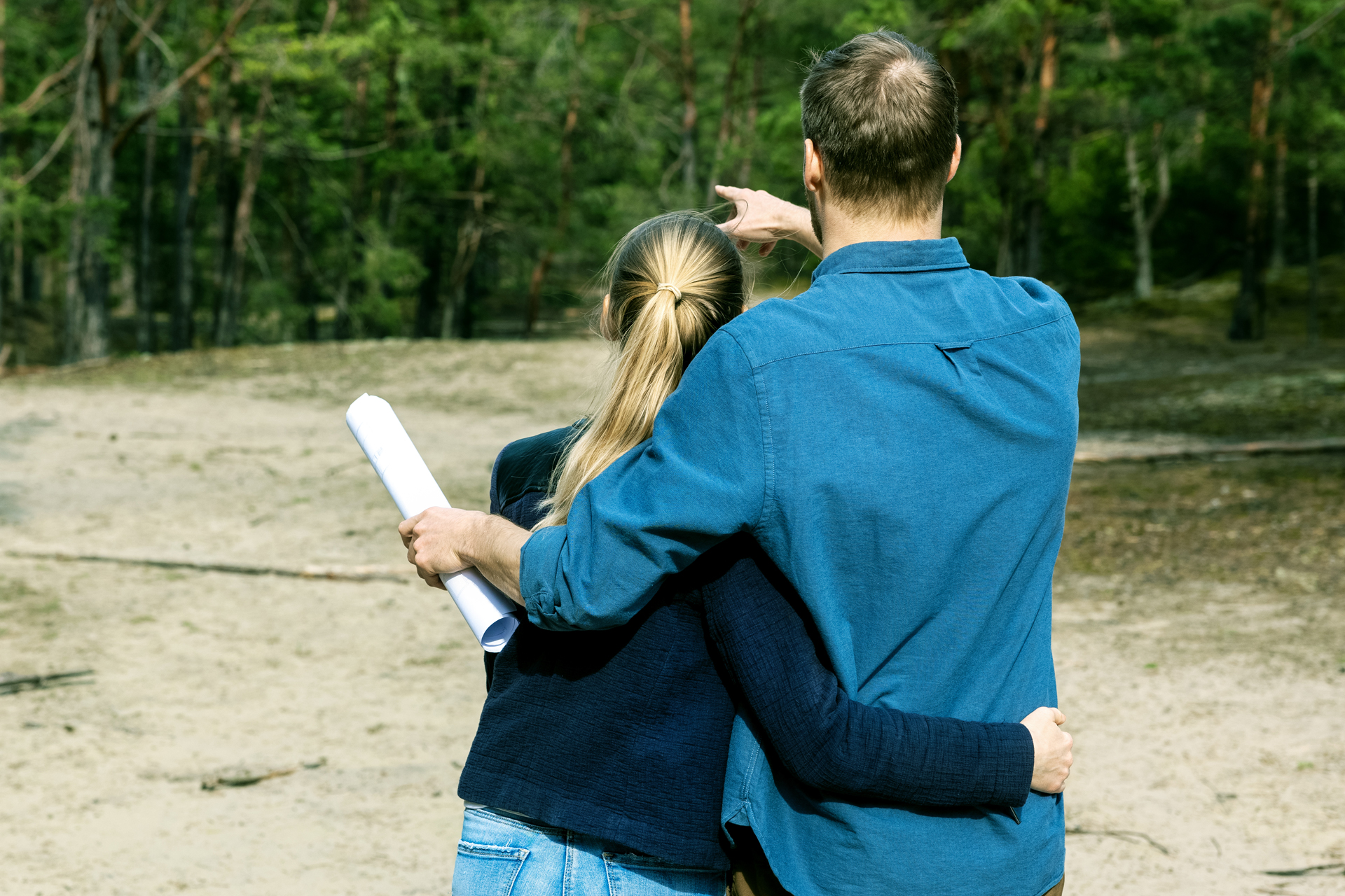 Couple surveying land where they will build their new house.