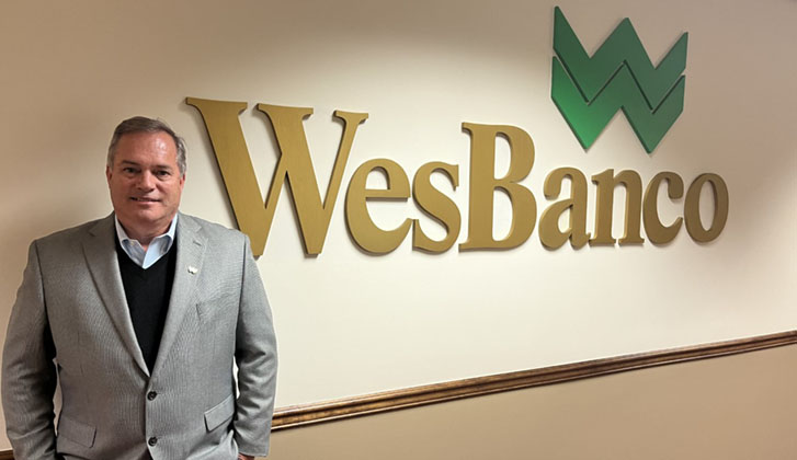 Image of Todd Clossin WesBanco CEO in front of WesBanco Logo at bank headquarters in Wheeling