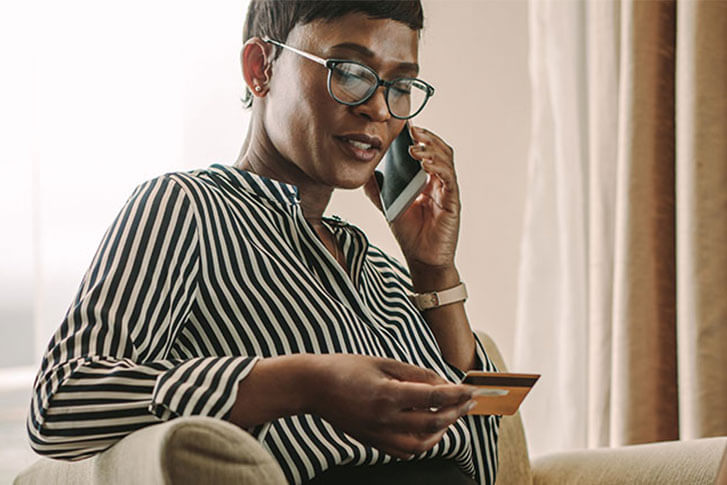 Woman looking at credit card