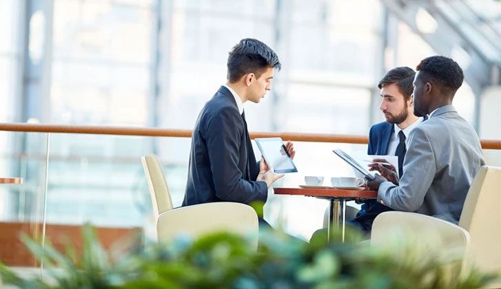 Group of businessmen having discussion of financial data