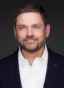 Headshot of Craig Kinslow in front of a dark grey background